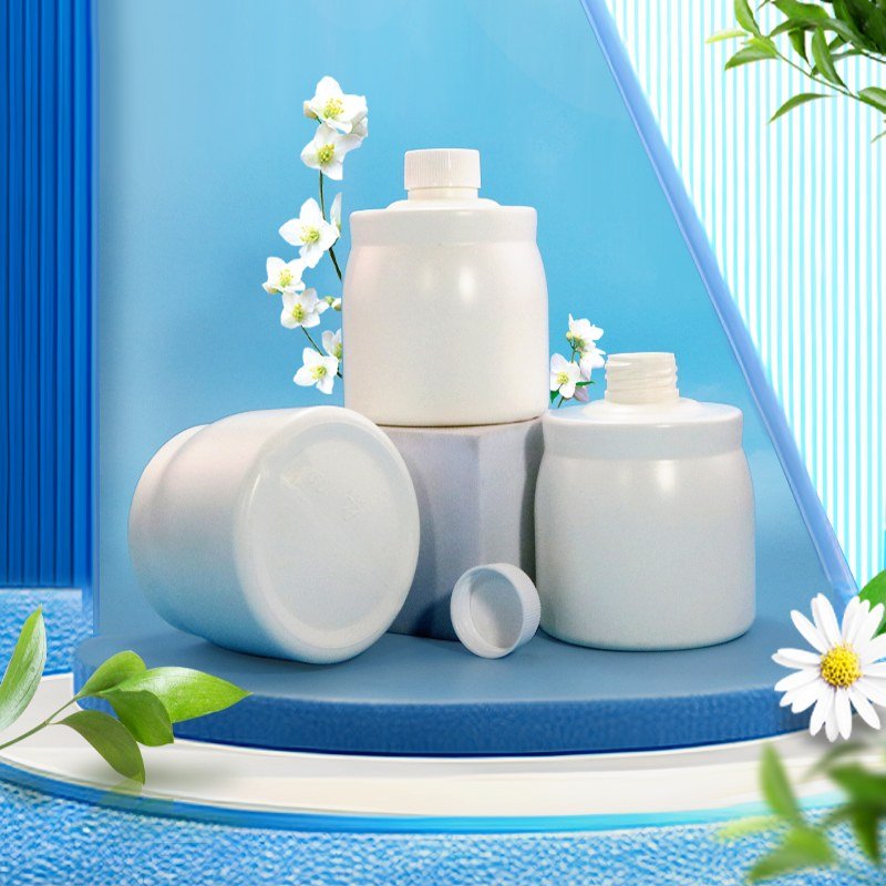 Three white PET cosmetic jars on a clean surface, the kind of primary pack a brand specifies with a verified post-consumer recycled content claim
